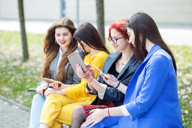 Beautiful girls sit and chat with gadgets on the b y6br2l6 min