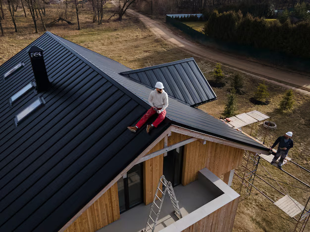 Long shot man with helmet sitting roof 23 2149343711