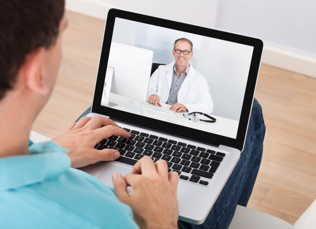 Man participating in online therapy session display