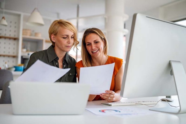 Business women working at the office on computer grgypt7 display
